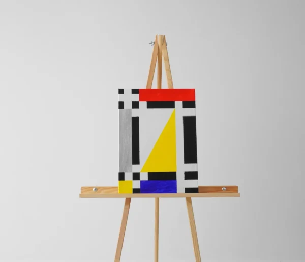Abstraktní obraz ve stylu Mondriana, geometrické tvary s černou, modrou, červenou a stříbrnou barvou. Dekorace do Vašeho domova za výhodné ceny.